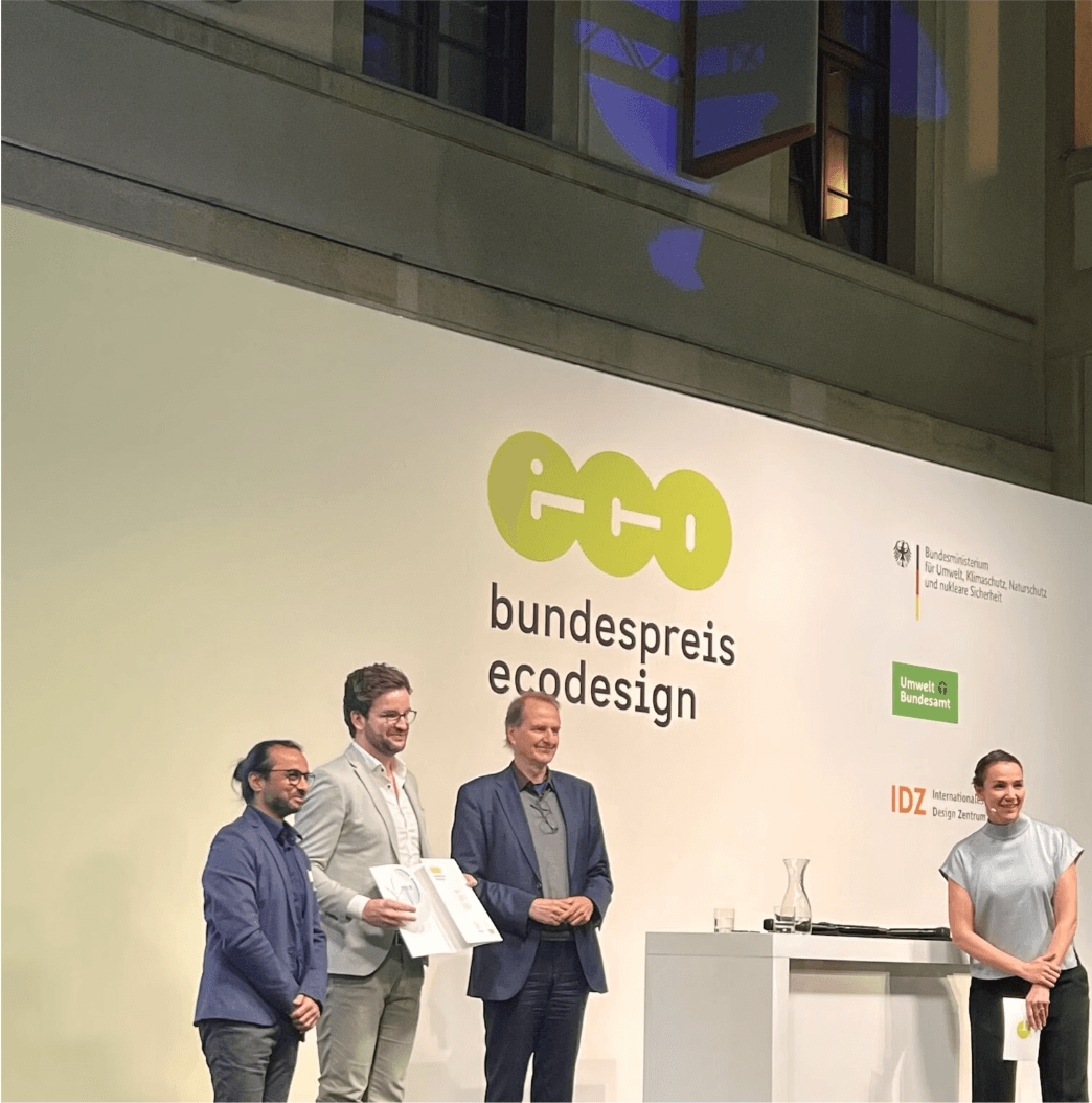FixFirst team receiving the Bundespreis Ecodesign award on stage