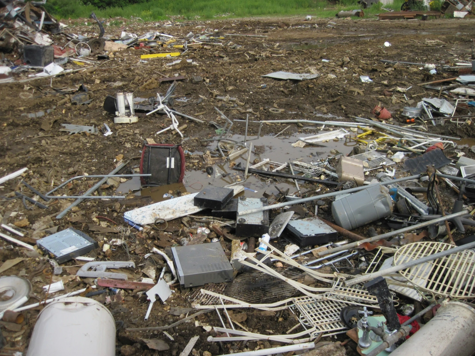 A field strewn with discarded electronics and scrap metal